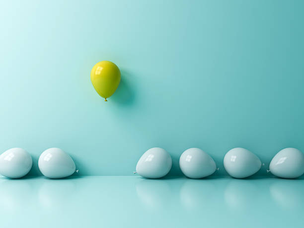 istock Stand out from the crowd and different concept One yellow balloon flying or floating above other white balls on light blue green pastel color wall background with reflections and shadows 3D rendering 2213735713