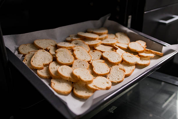 istock Sliced bread baking in oven with golden toasted crust on tray 2213735726