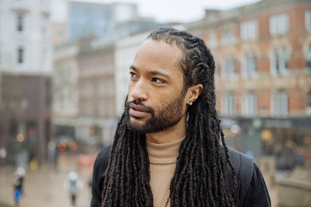 istock Black tourist with dreadlocks visiting city on rainy day 2213735845