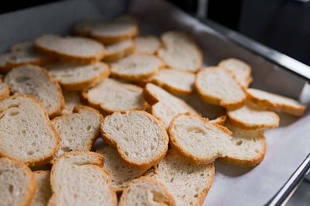 istock Pile of sliced bread on baking tray for toasting 2213735911