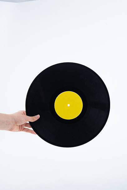 istock Hand Holding Black Vinyl Record with Yellow Label 2213736332