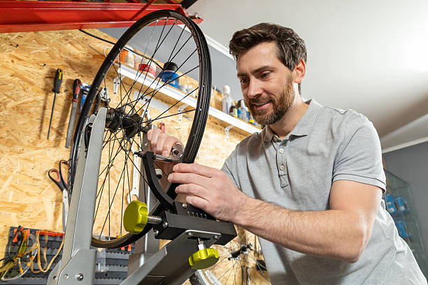 istock Mechanic in white gloves adjusting wheel 2213736622