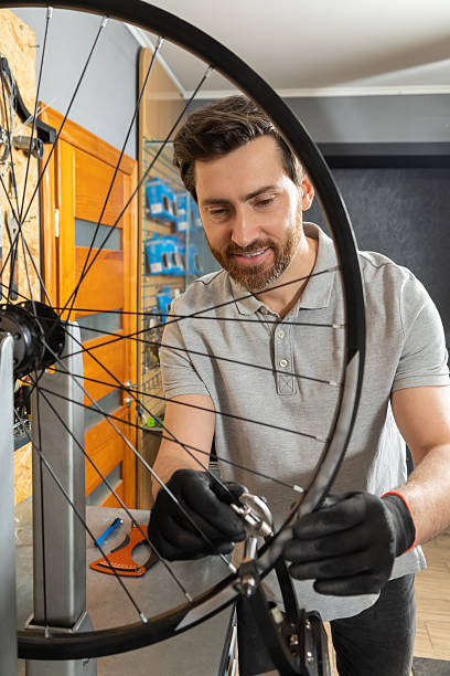istock Mechanic in black gloves gripping wheel 2213736634