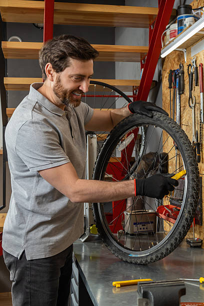 istock Mechanic in black gloves inspecting wheel 2213736660