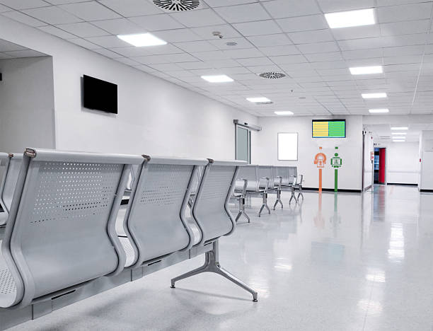 istock Modern Hospital Waiting Room with Empty Metal Chairs 2213736740