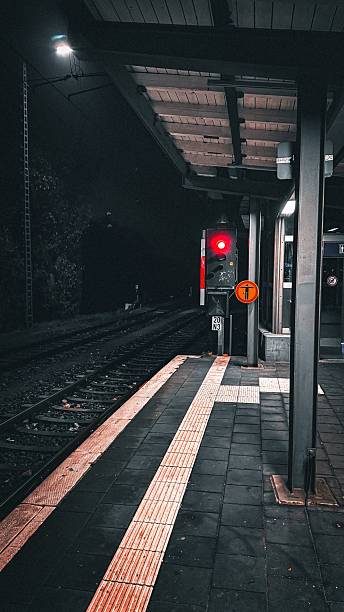 istock Sunset over an empty road with directional arrows, under a cloudy sky, creating a moody urban scene. 2213738306