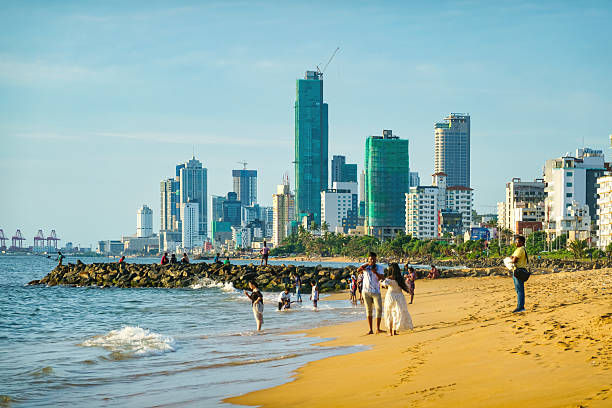 People enjoy the beach in Colombo, Sri Lanka on a sunny day.