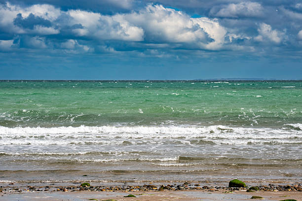 Tranquil coastal scene with inviting water on sunny day
