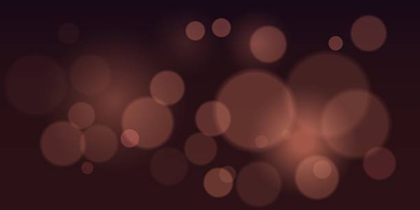 istock Bokeh. Soft brown blurred light circles on dark background. Ideal for festive backgrounds, elegant overlays, romantic designs, soft focus photography, light texture decoration. 2213744338