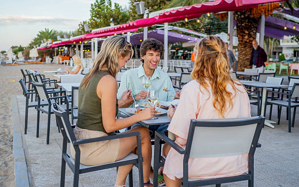 istock Friends enjoying a meal at a beachfront restaurant 2213744512