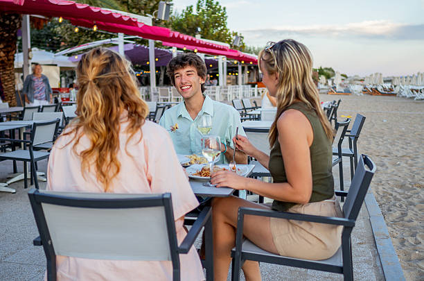 istock Friends enjoying dinner at a beach restaurant 2213744976