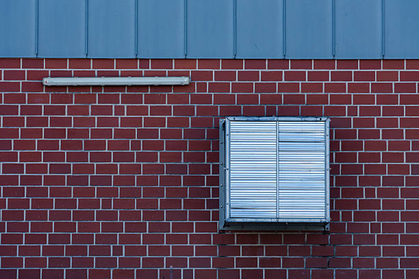 istock Air conditioning unit on a red brick wall with a blue roof 2213746742