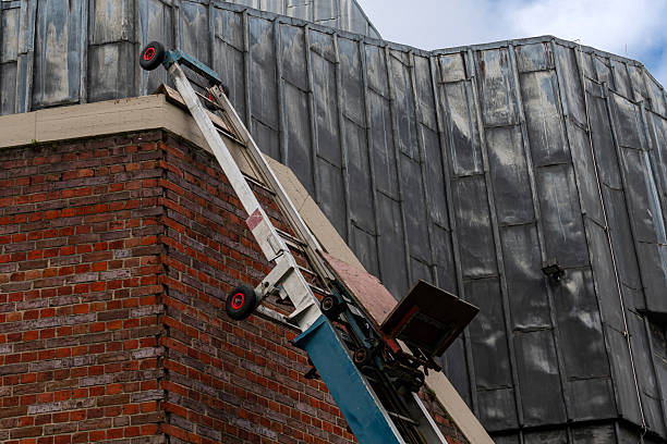 istock Construction ladder leans against a tall brick building 2213746953