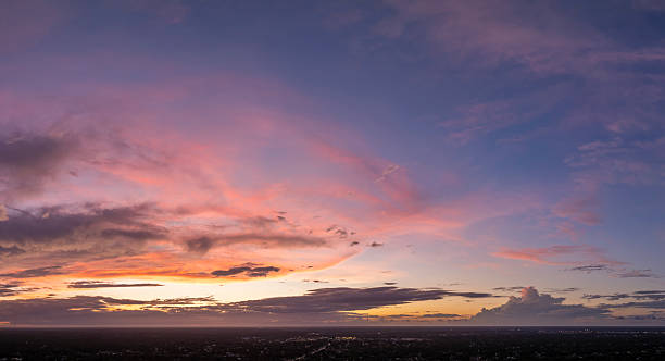 istock Evening sunset sky with colorful clouds over dark land. Panoramic skyscape 2213748841