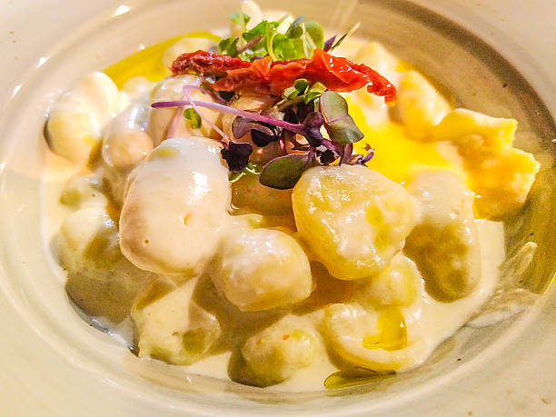 istock Creamy gnocchi with dried tomato and microgreens 2213749680