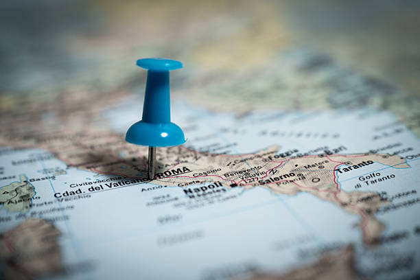 Blue push pin pointing rome on a map of italy