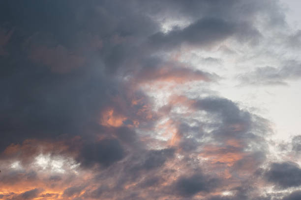 istock Dramatic clouds illuminate the evening sky during sunset over a tranquil landscape 2213750406