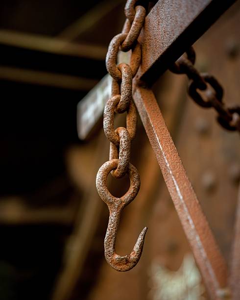istock Rusty metal chain close-up with hook 2213750474