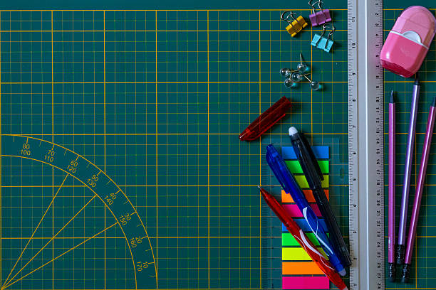 istock Assorted Stationery Items on Green Grid Mat 2213752216
