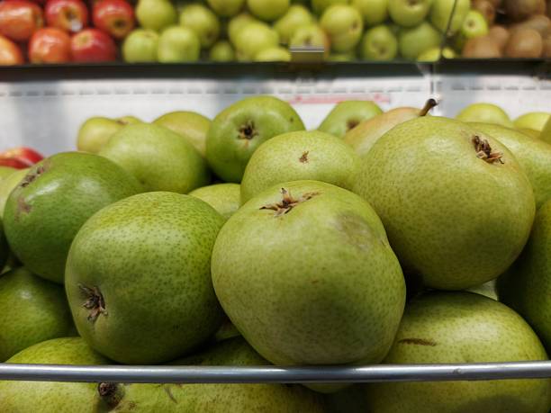 istock Green apples grouped together on a supermarket shelf 2213754945