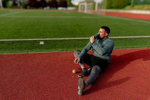 istock Athlete drinking water after training on running track 2213758075