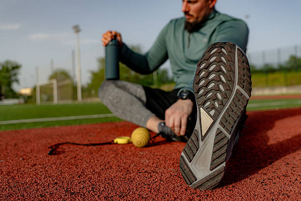 istock Athlete relaxing and drinking water after training on running track 2213758093