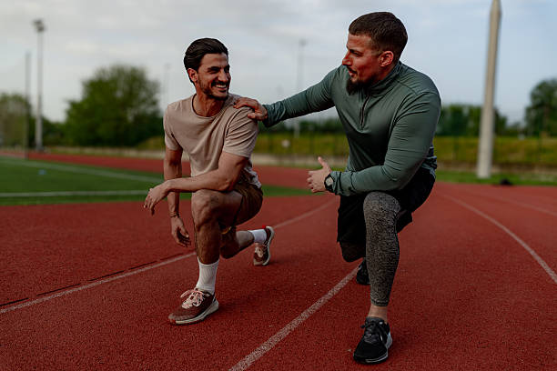 istock Coach motivating athlete during training on running track 2213758242