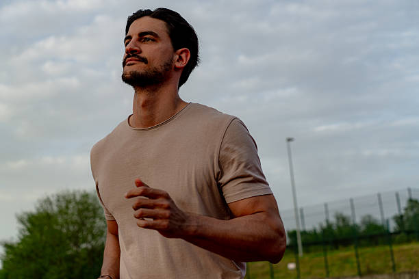 istock Young Man Running Outdoors in a Cloudy Day 2213758289