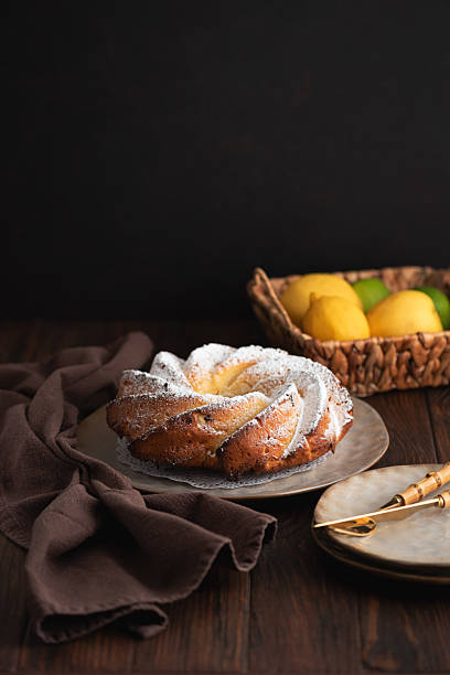 Lemon bundt cake powdered sugar on wooden table