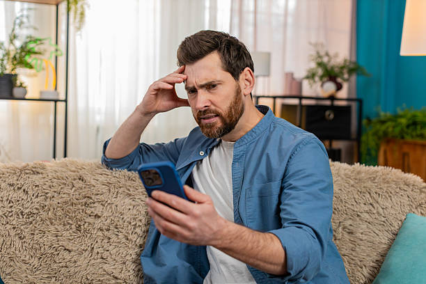 istock Man frustrated and nervous texting on smartphone, holding head, waiting anxiously for message reply 2213762690