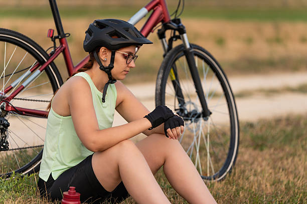 istock Female cyclist resting and checking smartwatch 2213763230