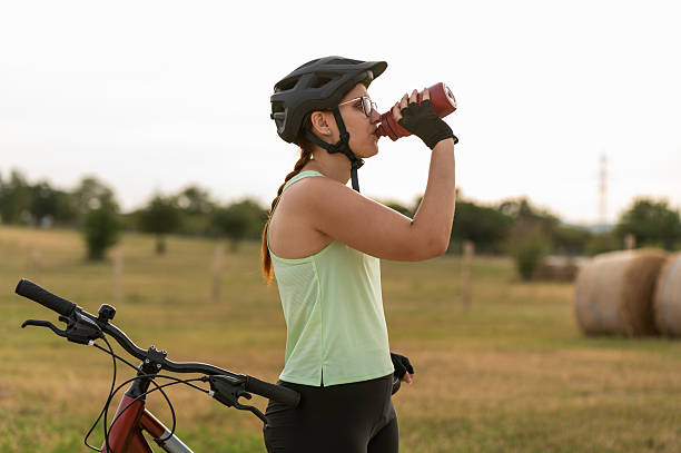 istock Female cyclist hydrating during outdoor ride 2213763348