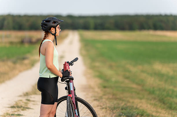 istock Female cyclist taking a break on a rural road 2213763367