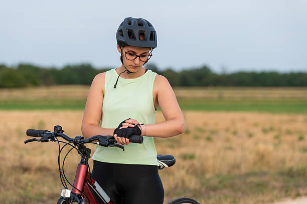istock Female cyclist checking her smartwatch for ride statistics 2213763457