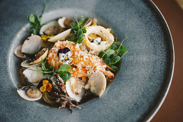 Pasta with seafood in a beautiful plate. Beautiful seafood dish.
