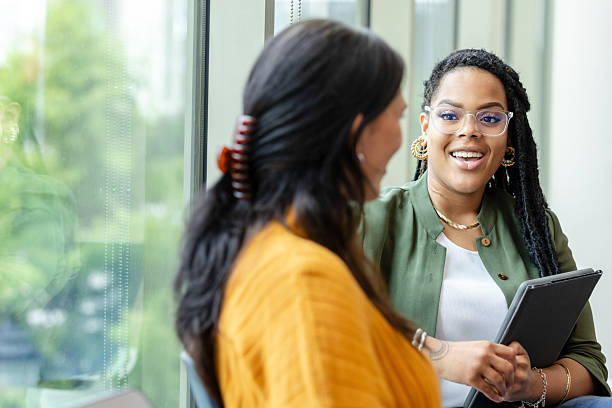 istock Two Diverse Women in Casual Discussion at Office 2213764711