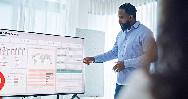 istock Group of business professionals meeting reviewing global data analytics discussing data analytics during a presentation, discussing strategy and growth standing at the office. Finance meeting concept. 2213765701