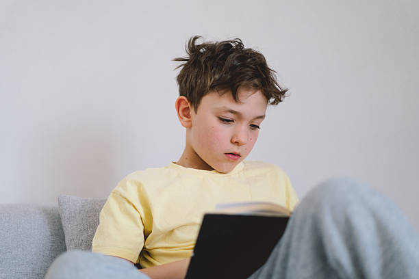 istock A boy is reading the holy bible 2213766871