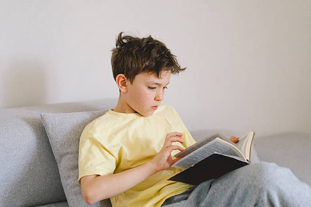 istock A boy is reading the holy bible 2213766981