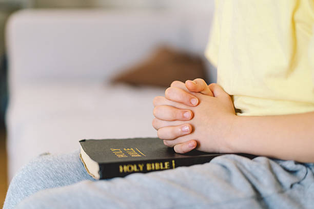 istock A boy is reading the holy bible 2213767051