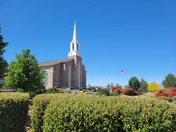 istock A church with a steeple is surrounded by trees and bushes 2213772693