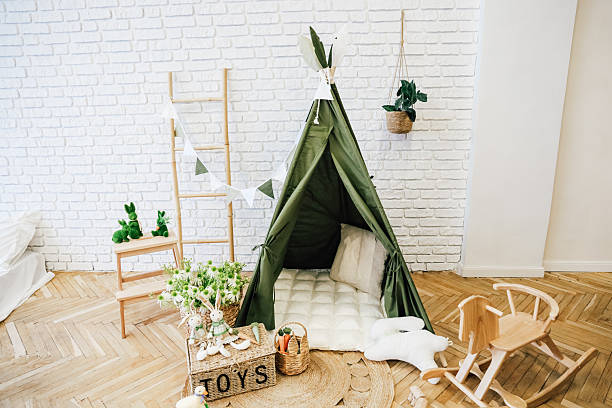 istock Cozy indoor play area with a green teepee and decorative elements for children 2213773615