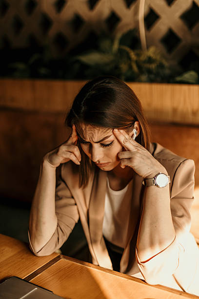 istock Stressed businesswoman suffering from headache at cafe table 2213778296