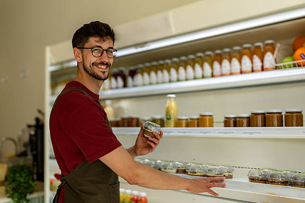 istock Shopkeeper Arranging Products on Shelves in Zero Waste Store 2213779157