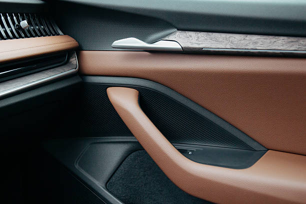 istock Car door interior with leather metal trim speaker Interior design featuring brown leather brushed metal and texture for luxury car 2213779920