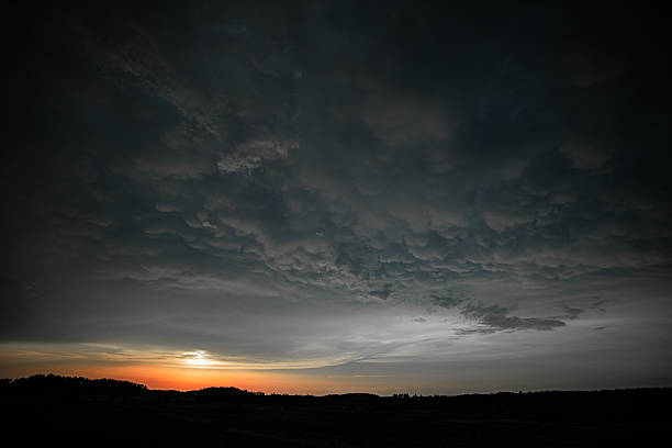 istock Dark Mammatus Clouds Rolling Over Landscape at Sunset 2213780325
