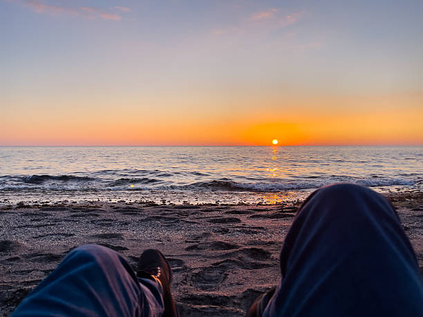 istock Serene evening scene showcasing a captivating sunset over the ocean while sitting on the beach. 2213781627