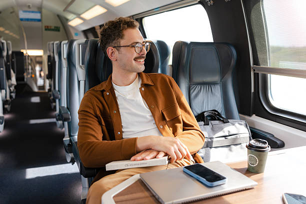 istock Man on a train journey, enjoying the view 2213782093