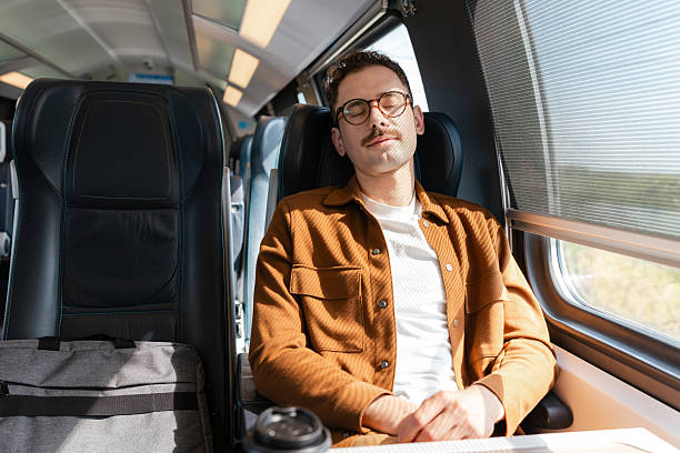 istock Man relaxing on a train journey with a calm and peaceful expression 2213782140