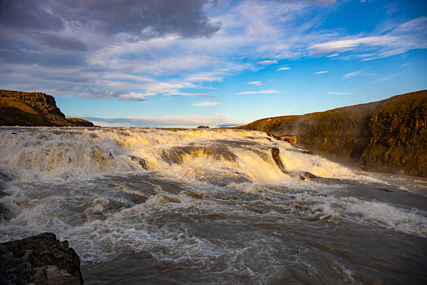 Gullfoss, a famous waterfall located on the Golden Circle route in Iceland. A powerful natural landmark surrounded by scenic landscapes and popular with tourists.